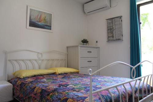 a bedroom with a bed and a dresser at Apartments by the sea Postira, Brac - 22205 in Postira