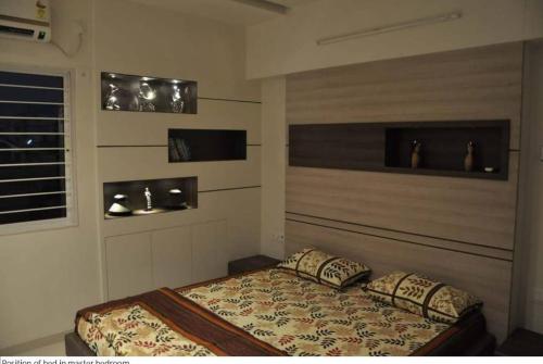 a bedroom with a bed with two pillows on it at Peaceful Retreat 3BHK For six person in Vadodara