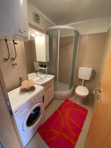 a bathroom with a washing machine and a toilet at Seaside holiday house Postira, Brac - 22663 in Postira