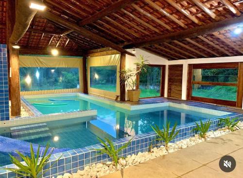 a large swimming pool in a house at Chalé Pousada em Salesopolis 7 in Salesópolis