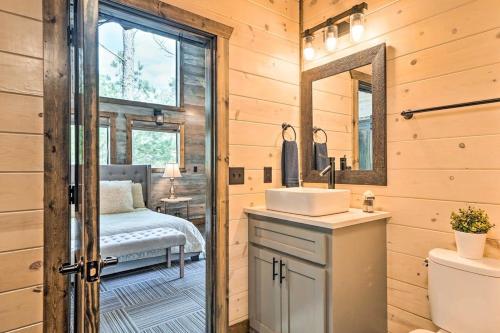a bathroom with a sink and a mirror at Family Getaway 10-Bed Cabin w Hot tub & Firepit in Broken Bow