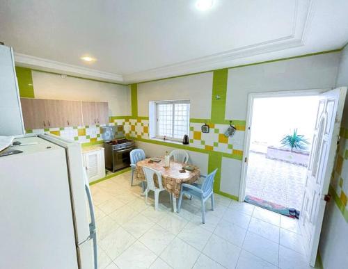 a kitchen with a table and chairs in a room at vibrant bright house of La Marsa in La Marsa