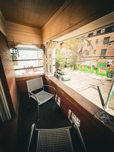 a chair sitting in a room with a window at Off Broadway B & B in Denver