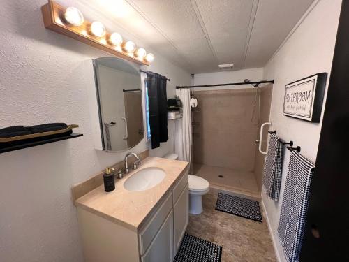 a bathroom with a sink and a toilet at Tiki Escape w/ Amazing Mountain and Marsh Backdrop in Rockaway Beach