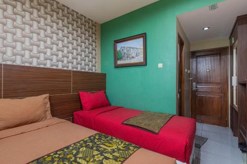 Кровать или кровати в номере Hotel DMadinah inn Gentan