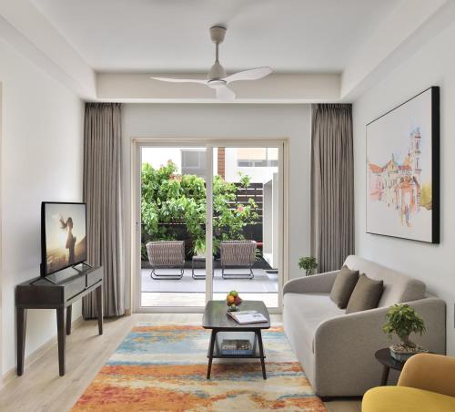 a living room with a couch and a table at Citadines Arpora Nagoa Goa in Arpora