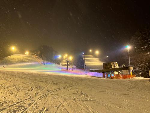 a snow covered ski slope at night with lights at The LODGE ABASHIRI in Abashiri