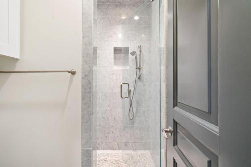 a bathroom with a shower with a glass door at Serenity Now - Private Pool,5 Bikes,Gulf Views, Steps to the Beach and Seaside! in Seagrove Beach