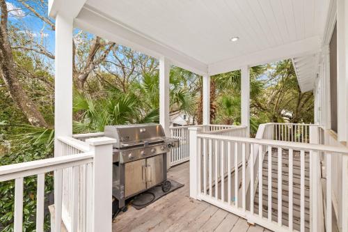 a white porch with a grill on it at Serenity Now - Private Pool,5 Bikes,Gulf Views, Steps to the Beach and Seaside! in Seagrove Beach