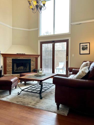 a living room with a coffee table and a fireplace at 4 Bedroom Home in Best Location Parking Fireplace Back Yard Pets Welcome in Chicago