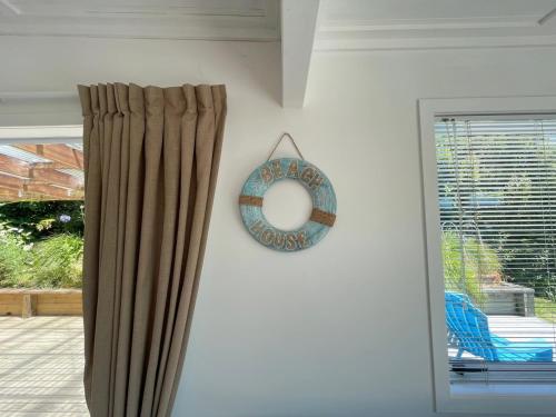 a mirror hanging on a wall next to a window at Oneroa Village Oasis - Stay Waiheke in Blackpool
