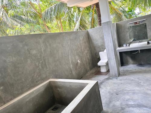 a bathroom with a bath tub and a toilet at Blue Mountains View in Dambulla