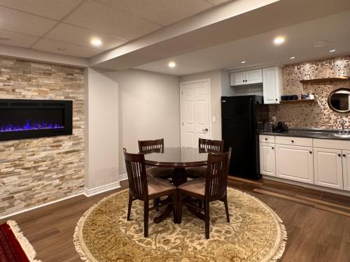 a kitchen and dining room with a table and chairs at Spacious Bottom-Floor 2BR Suite in Innisfil