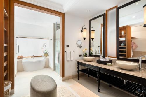 a bathroom with two sinks and a tub at Santiburi Koh Samui in Mae Nam