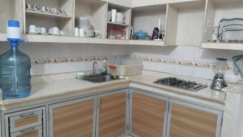 a kitchen with a sink and a bottle of water at Villa Concha in Pueblo Bello