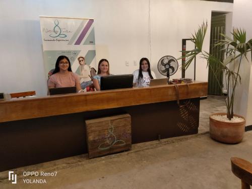 a group of women sitting at a counter with their laptops at Irakara hotel campestre in La Palma