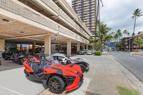 a red motorcycle parked in front of a building at #Waikiki Dream - Cozy & Modern Studio in Honolulu