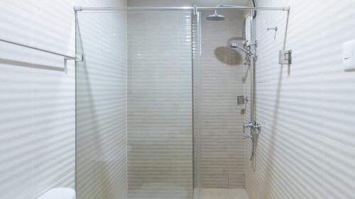 a shower with a glass door in a bathroom at Asrodel Hotel RedPartner in Davao City