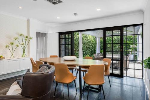 a dining room with a table and chairs at Iris @ Norwood - Luxe 4BR in Norwood