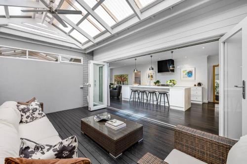 a living room with a couch and a table at Iris @ Norwood - Luxe 4BR in Norwood