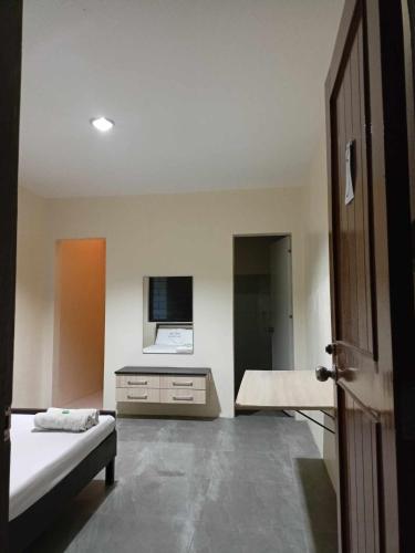 a room with a bed and a desk in it at Wjv Inn Talamban in Cebu City