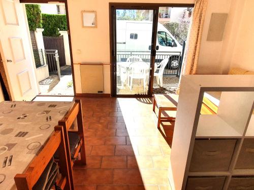 une cuisine avec une table et une vue sur un balcon dans l'établissement Studio avec coin-nuit, piscine, terrasse et parking à Sainte-Maxime, proche plages et commerces - FR-1-780-74, à Sainte-Maxime