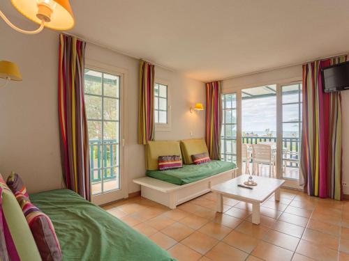 a living room with a couch and a table at Grand appartement familial avec piscine près de Saint-Jean-de-Luz - FR-1-2-439 in Urrugne
