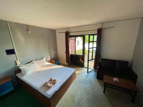 a bedroom with a bed with a bow on it at Bamby Chilling House in Sauraha