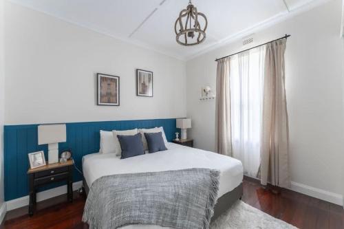a bedroom with a large bed and a window at View Point: Ocean Views & Near CBD in Burnie