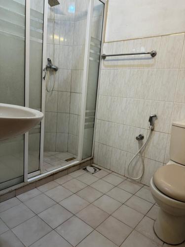 a bathroom with a shower and a toilet and a sink at Natures Bliss Holidays in Ja-Ela