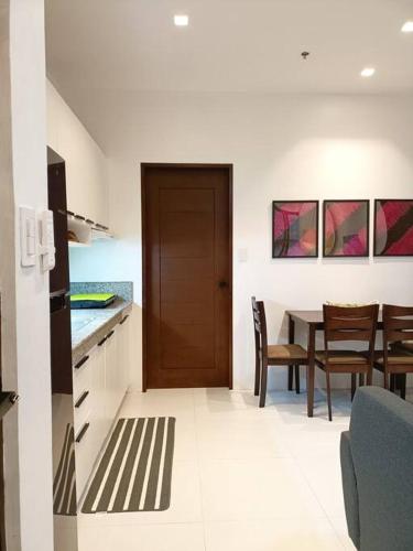 a kitchen and dining room with a table and chairs at JD&S Apartments Unit 2 in Iligan City
