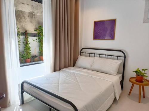a bed in a room with a window at JD&S Apartments Unit 2 in Iligan City