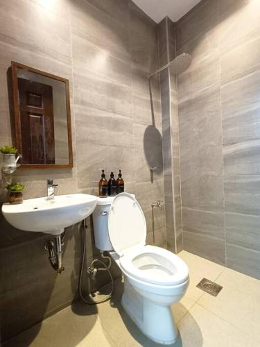 a bathroom with a white toilet and a sink at JD&S Apartments Unit 2 in Iligan City