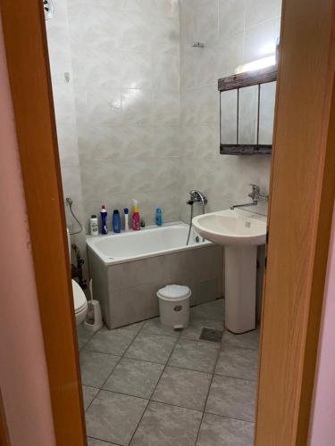 a bathroom with a tub and a toilet and a sink at Struga Studio Appartment - 20 meters from the beach in Struga