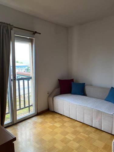 a bedroom with a bed and a large window at Struga Studio Appartment - 20 meters from the beach in Struga