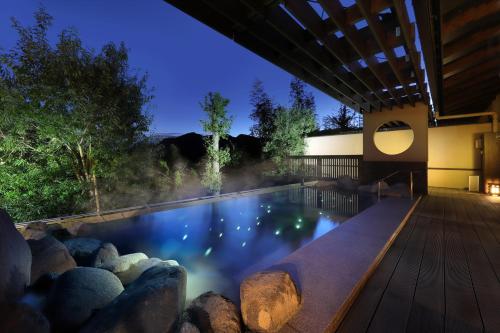 a swimming pool in a backyard at night at Yumenoi in Himeji