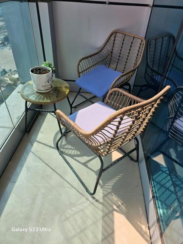 - Balcón con 2 sillas y mesa de centro en Ajman Cornish Residence, en Ajman
