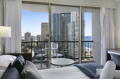 a bedroom with a bed and a view of the city at Ocean View 2-Bed Studio In the Heart of Surfers in Gold Coast