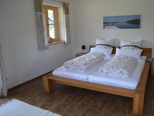 two beds in a room with white walls at Lovely apartment in Gaißach in Gaißach