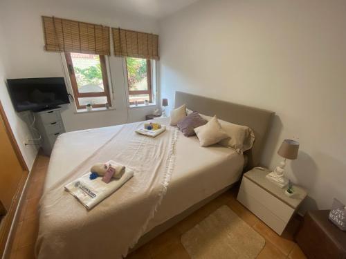 a bedroom with a bed with two items on it at E041 Apartment Albir in L’Alfàs del Pi