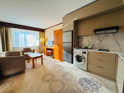 a kitchen with a washer and dryer in a room at Flower Hotel Ulaanbaatar in Ulaanbaatar