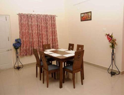 a dining room table and chairs in a room at sucasa homes (home away from home guest services pvt ltd) in Hyderabad