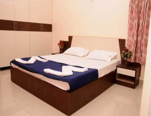 a bedroom with a bed with towels on it at sucasa homes (home away from home guest services pvt ltd) in Hyderabad