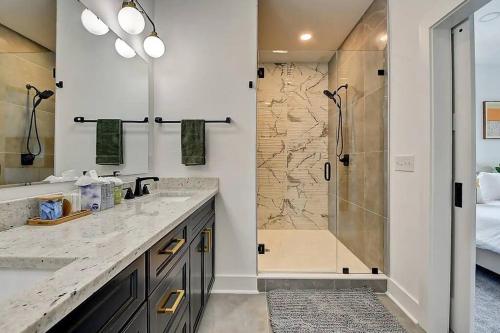 a bathroom with a shower and two sinks and a showeriterator at NEW Luxury Home 10 Min To Downtown Pool Table in Indianapolis