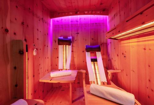a room with two beds in a room with purple lights at Chalet Bucher in Ehrwald