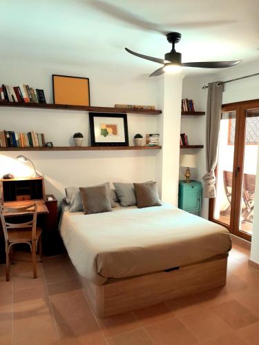 a bedroom with a bed and a ceiling fan at Apartamento Montesol in Sanet y Negrals