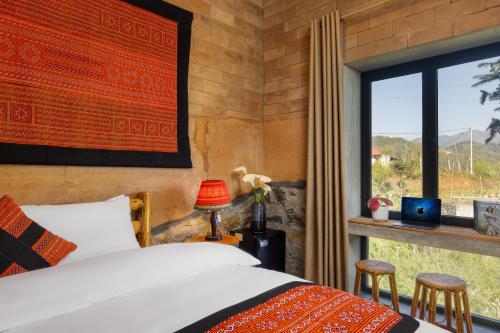 a bedroom with a bed and a window at Sapaxa Spring Garden Ecolodge in Sa Pa