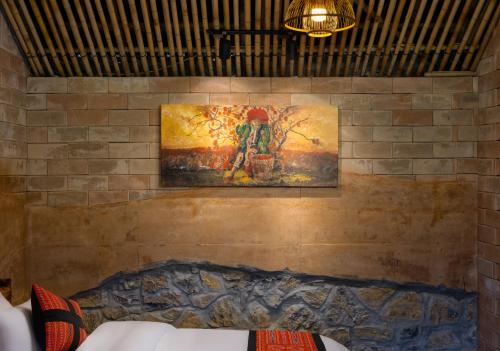 a painting on a brick wall with a painting on it at Sapaxa Spring Garden Ecolodge in Sa Pa