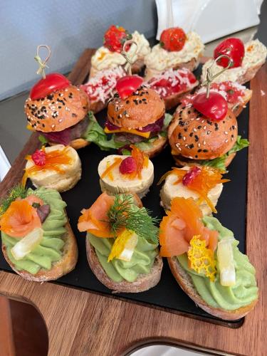 a tray of sandwiches with different types of food at Aria by Brilliant in Zalău