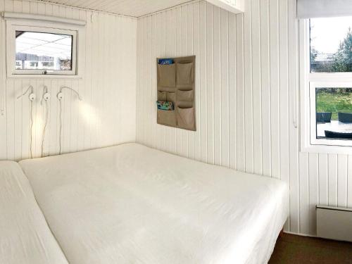 a white bed in a room with two windows at Holiday home Middelfart IV in Middelfart
